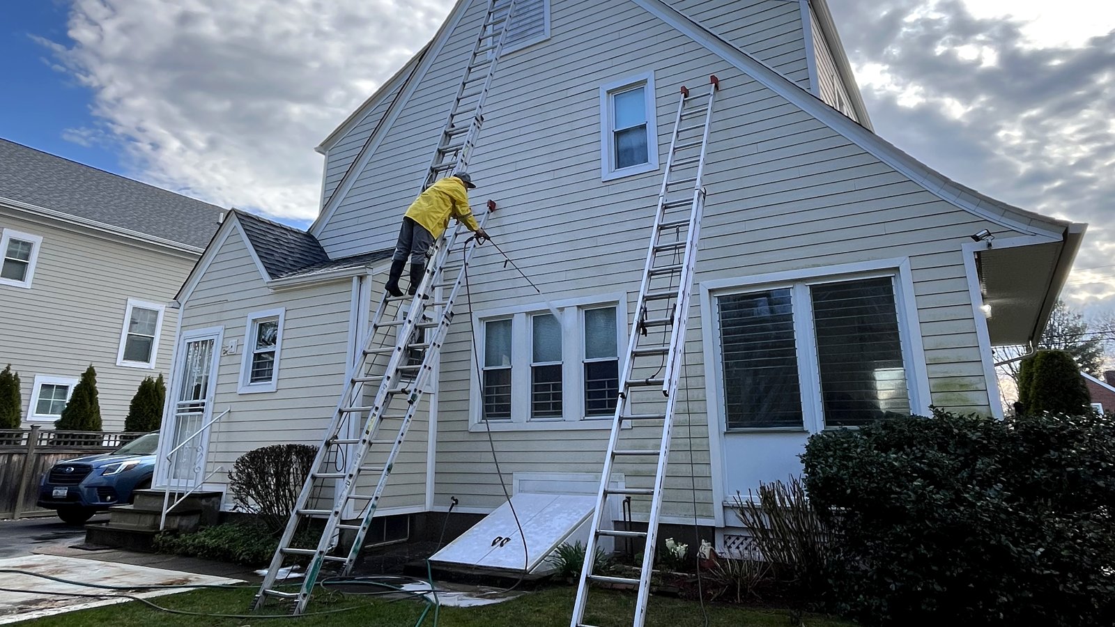 E.M Construction crew maintaining and repairing a home exterior